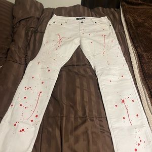 Men’s white jeans with red paint splatter